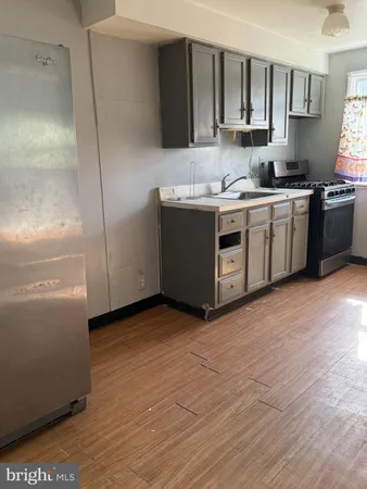 a kitchen with a sink cabinets and stainless steel appliances