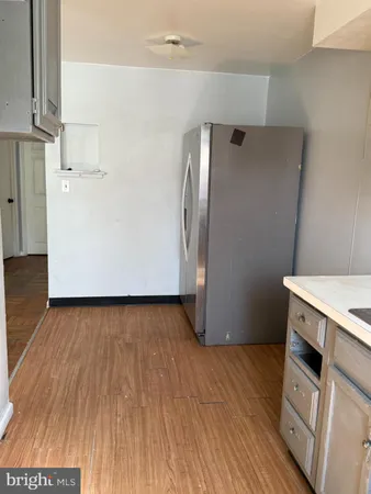 an empty room with wooden floor and entrance
