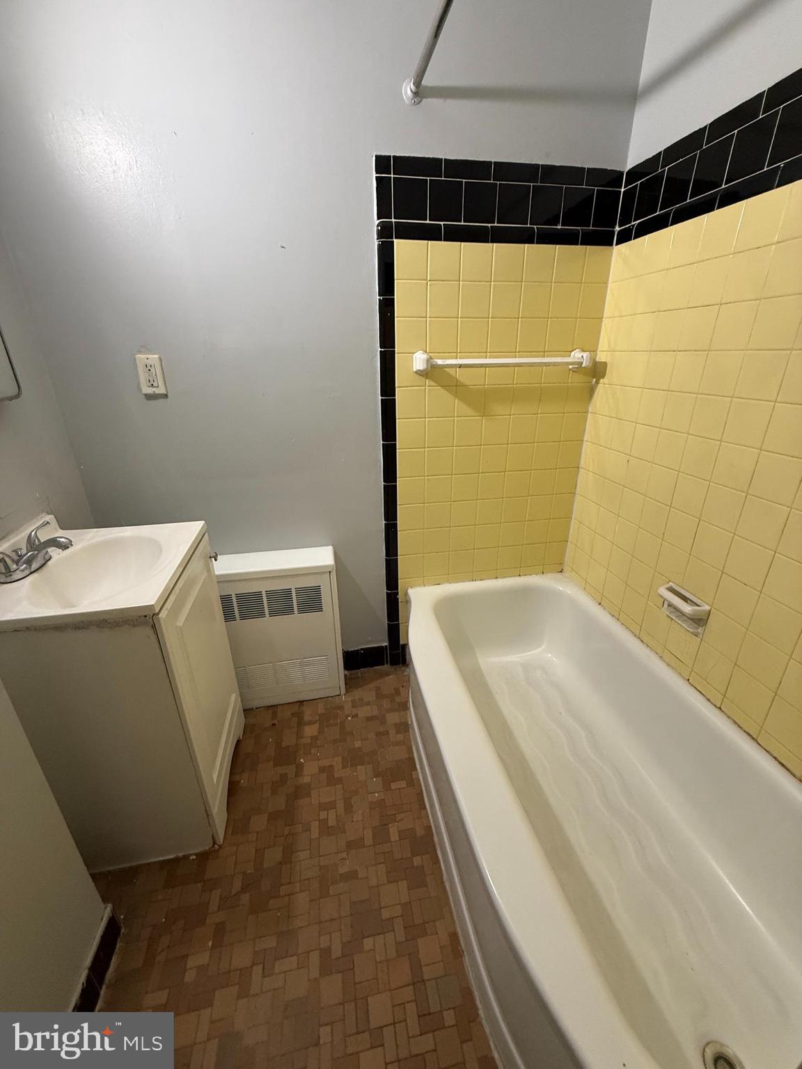 557 Wiltshire Road Upper Darby, PA 19082 - Photo 9 of 27 a bathroom with a tub a sink and a shower