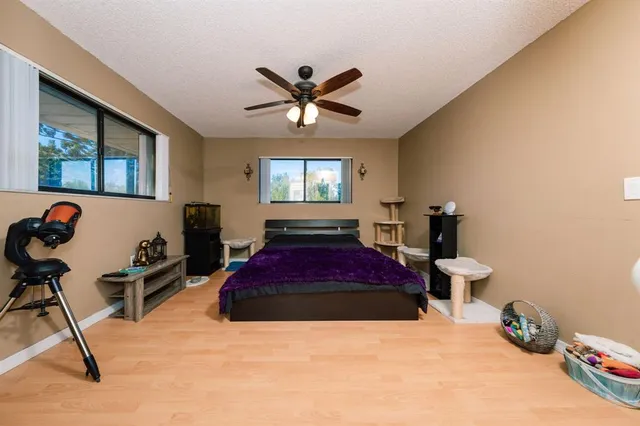 a spacious bedroom with a bed and a chandelier