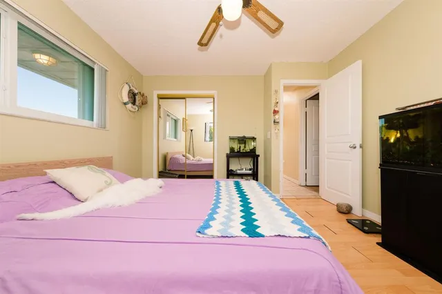 a bedroom with a bed and a mirror