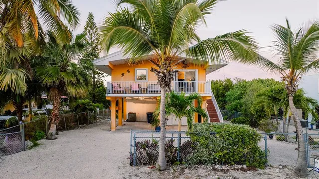 a view of a palm trees in front of a house