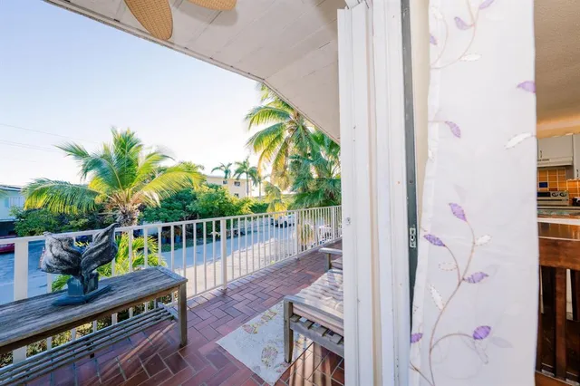 a balcony with furniture and potted plant