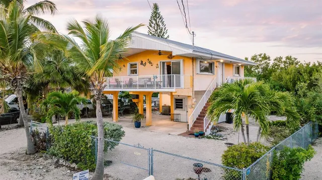 a front view of multiple houses with yard