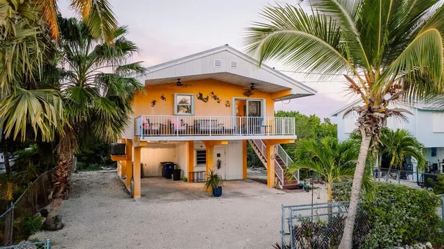 a view of swimming pool with palm trees