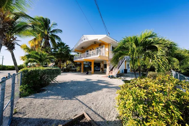 an aerial view of a house with swimming pool and garden