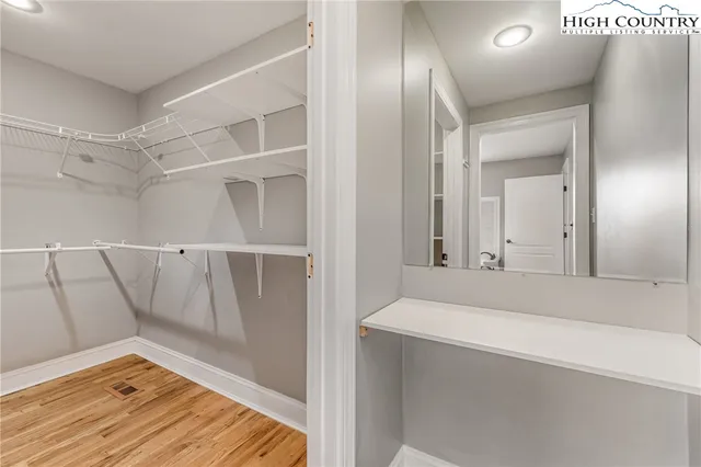 a view of a livingroom with a ceiling fan and wooden floor