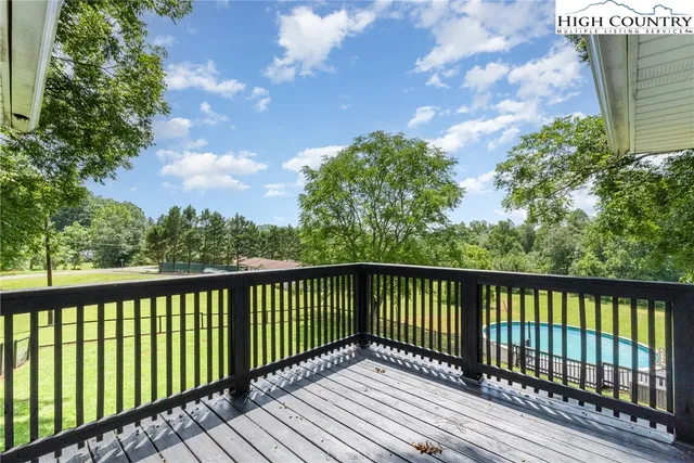 a view of a balcony with wooden floor and fence