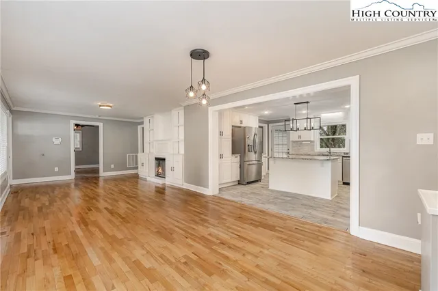 a view of a kitchen with a sink and wooden floor