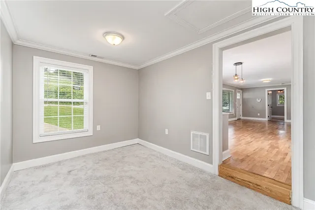 an empty room with windows and closet