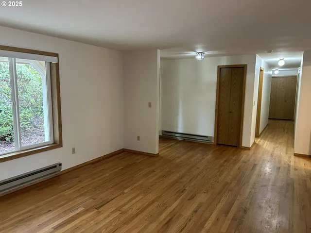 an empty room with a fireplace and window