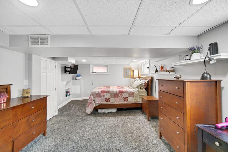 1012 177th Place Hammond, IN 46324 - Photo 19 of 26 a bed room with a bed and a dresser