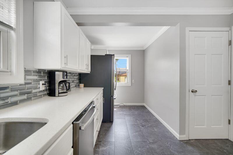 1012 177th Place Hammond, IN 46324 - Photo 9 of 26 a kitchen with a sink and a refrigerator