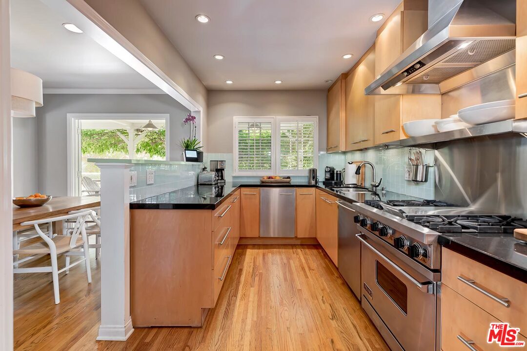 10629 Rountree Road Los Angeles, CA 90064 - Photo 14 of 37 a kitchen with stainless steel appliances a stove a sink and a microwave