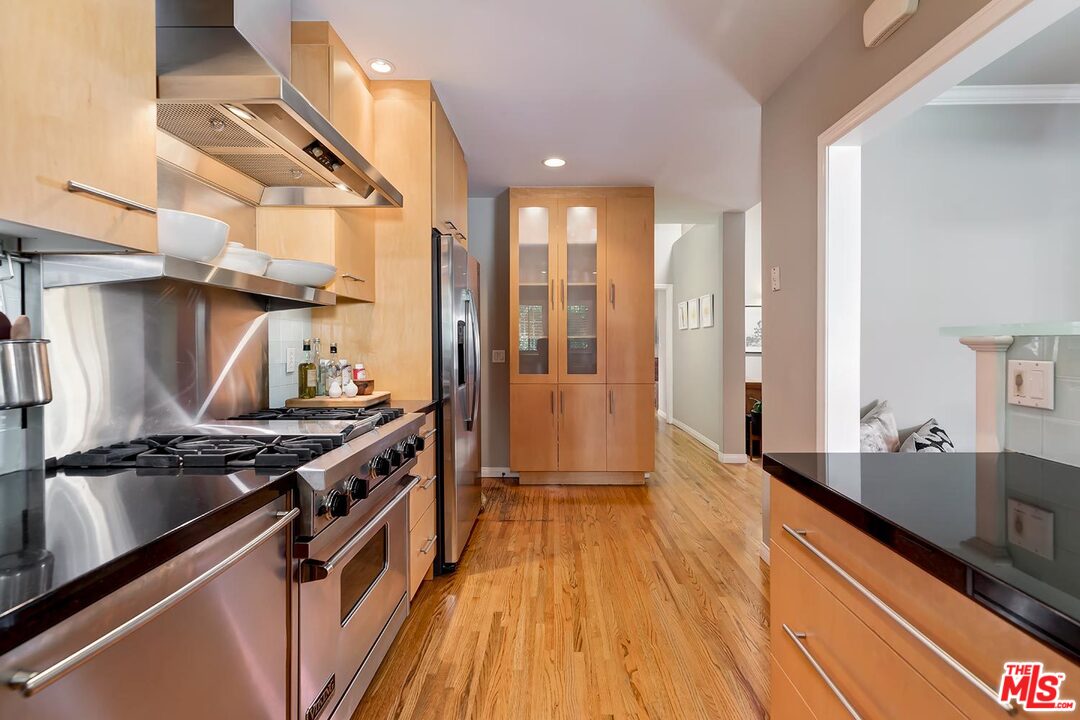 10629 Rountree Road Los Angeles, CA 90064 - Photo 15 of 37 a kitchen with stainless steel appliances a sink a counter top space and cabinets