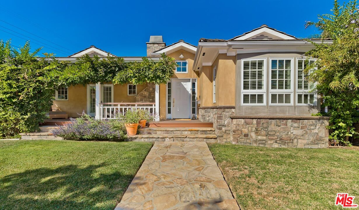 10629 Rountree Road Los Angeles, CA 90064 - Photo 2 of 37 a front view of a house with a yard and potted plants