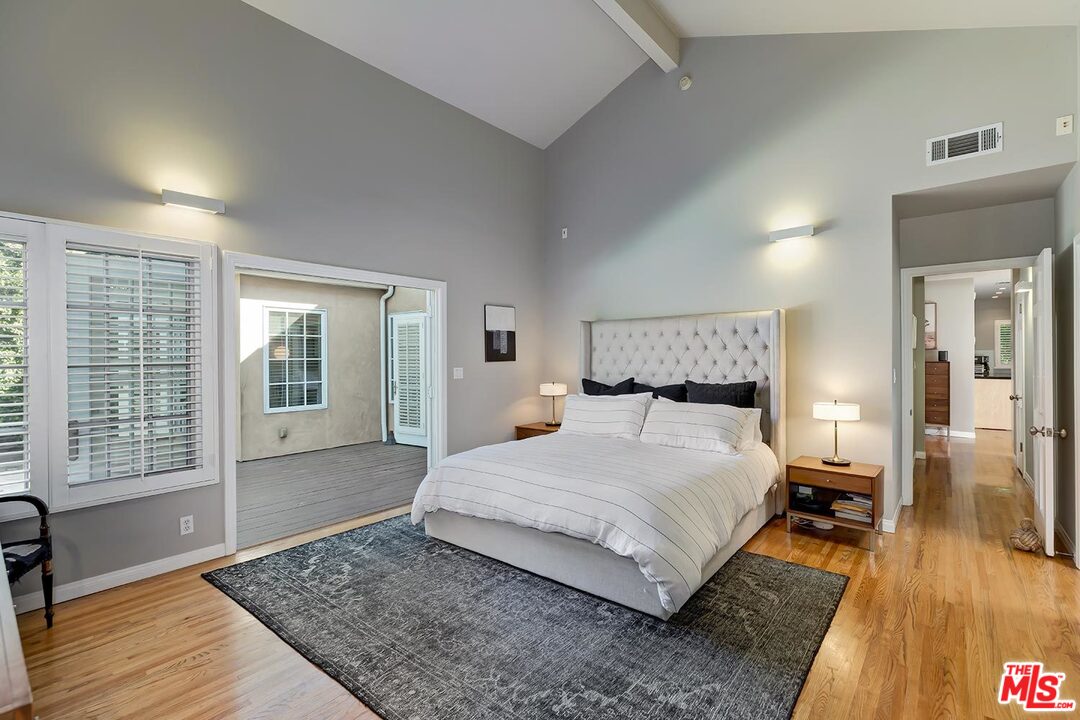 10629 Rountree Road Los Angeles, CA 90064 - Photo 21 of 37 a large bedroom with a bed and wooden floor