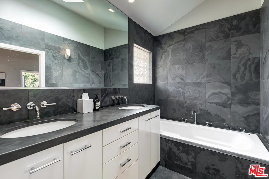 10629 Rountree Road Los Angeles, CA 90064 - Photo 23 of 37 a bathroom with a double vanity sink and a mirror