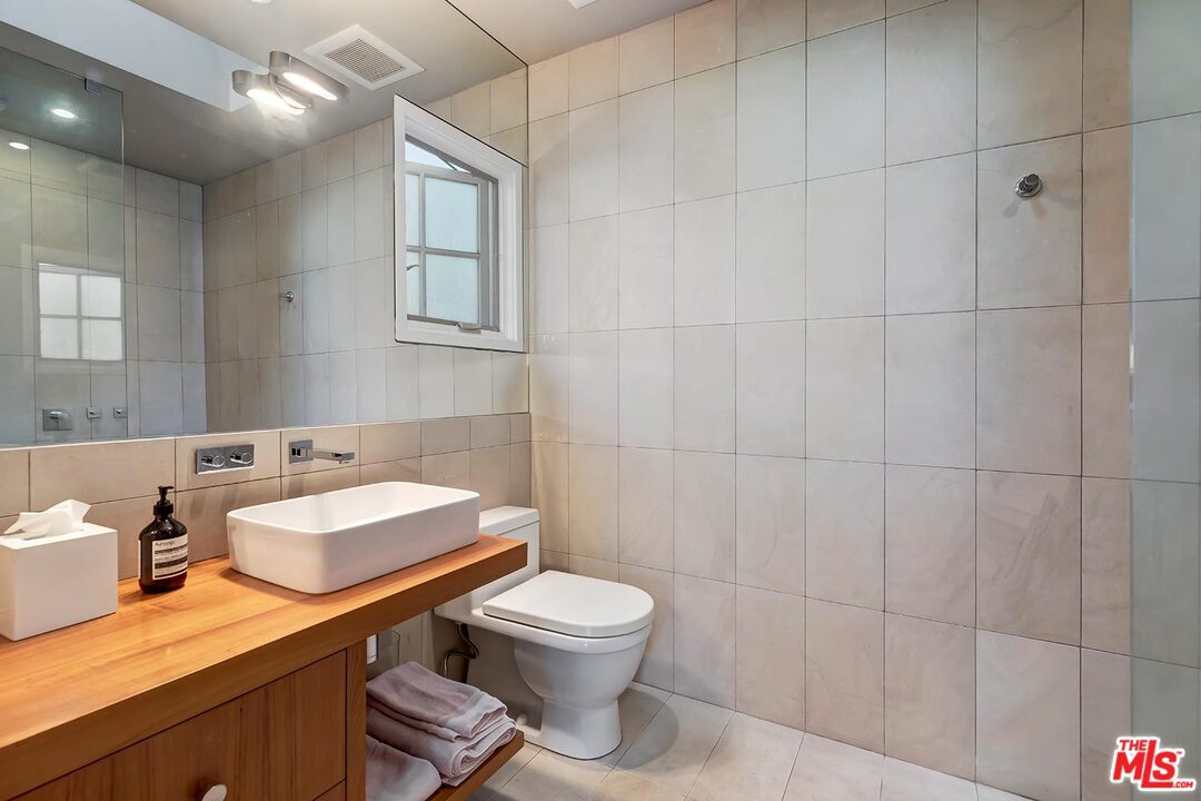 10629 Rountree Road Los Angeles, CA 90064 - Photo 28 of 37 a bathroom with a sink toilet and shower