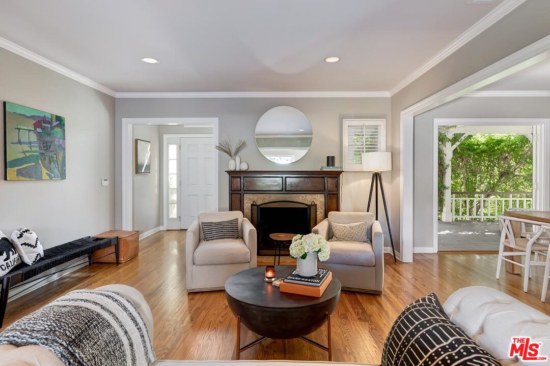 10629 Rountree Road Los Angeles, CA 90064 - Photo 4 of 37 a living room with furniture a fireplace and a large window