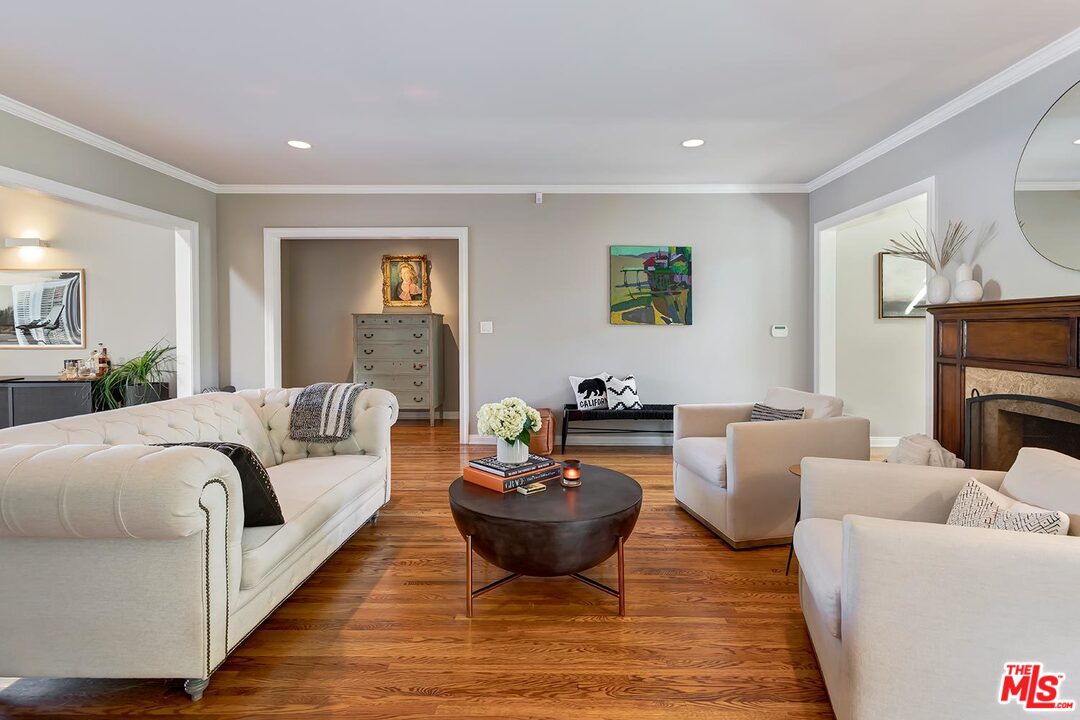 10629 Rountree Road Los Angeles, CA 90064 - Photo 8 of 37 a living room with furniture a lamp and a fireplace
