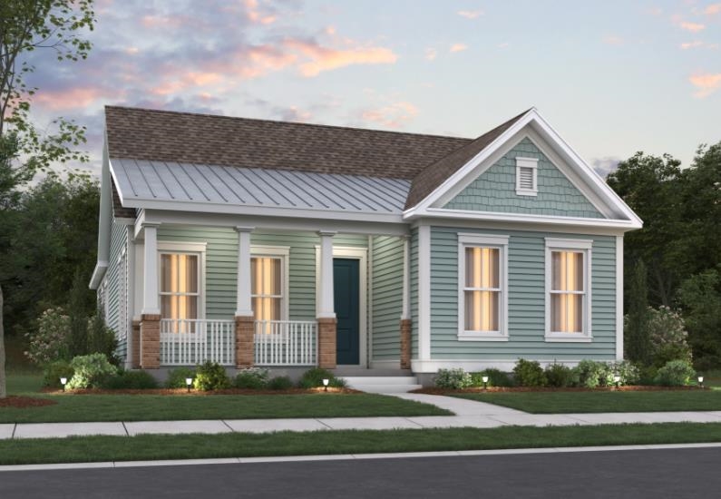 View of front facade with covered porch, a shingled roof, and a front lawn