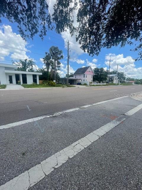 2445 Webber Street Sarasota, FL 34239 - Photo 3 of 16 a view of a house with a yard and large trees