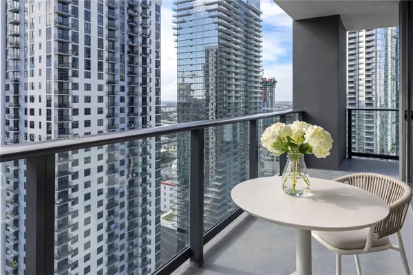 a living room with furniture a large window and a flat screen tv