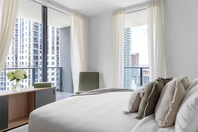 a view of a patio with table and chairs potted plants and palm trees