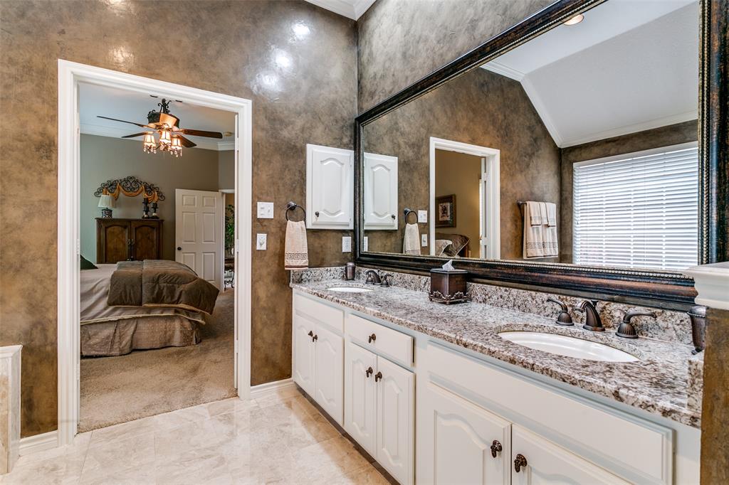 303 Old York Road Irving, TX 75063 - Photo 16 of 26 a en suite bathroom with double vanity and a mirror