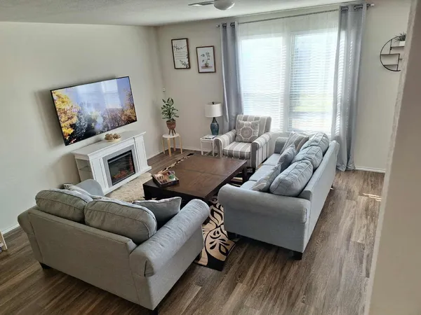a living room with furniture and a flat screen tv