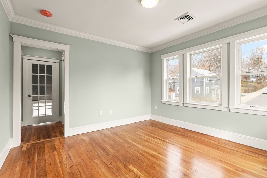 564 Lagrange Street, Unit 2 Boston, MA 02132 - Photo 12 of 27 a view of an empty room with wooden floor and a window
