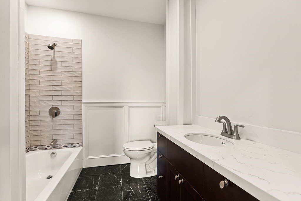 564 Lagrange Street, Unit 2 Boston, MA 02132 - Photo 13 of 27 a bathroom with a sink a toilet and bathtub