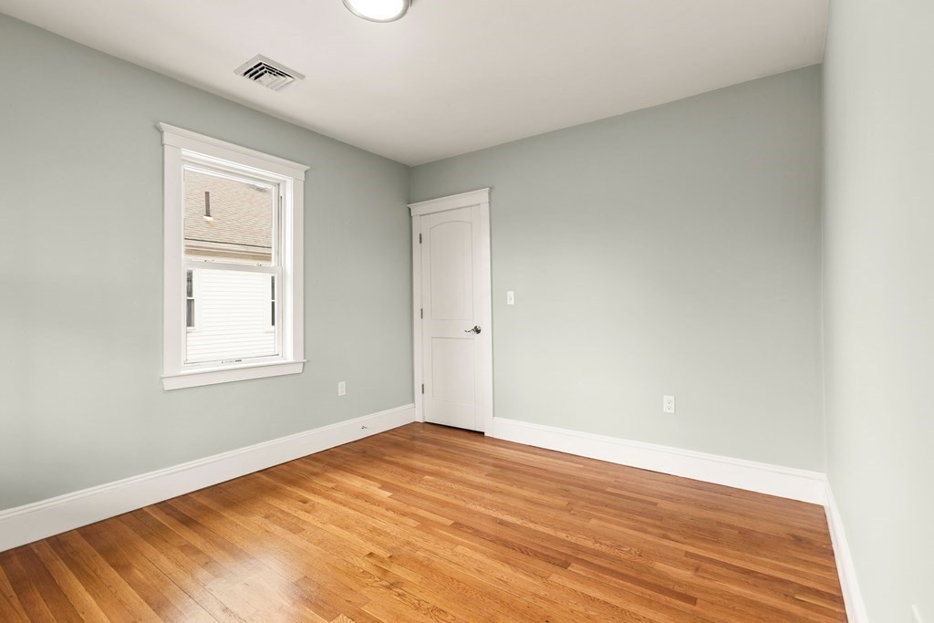 564 Lagrange Street, Unit 2 Boston, MA 02132 - Photo 19 of 27 a view of empty room with wooden floor and fan