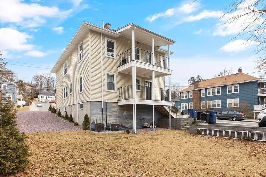 564 Lagrange Street, Unit 2 Boston, MA 02132 - Photo 23 of 27 a view of a building with a yard