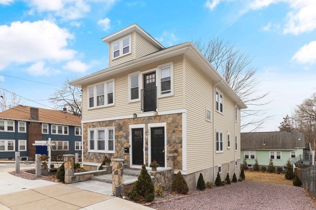 564 Lagrange Street, Unit 2 Boston, MA 02132 - Photo 27 of 27 a front view of a house with cars parked