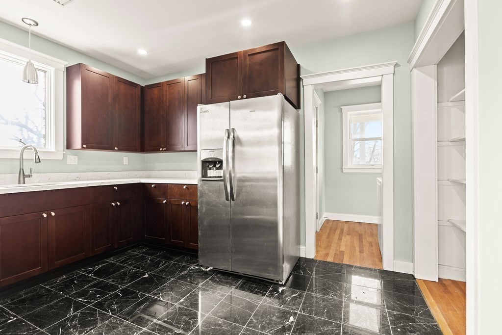 564 Lagrange Street, Unit 2 Boston, MA 02132 - Photo 5 of 27 a kitchen with stainless steel appliances a refrigerator and a sink