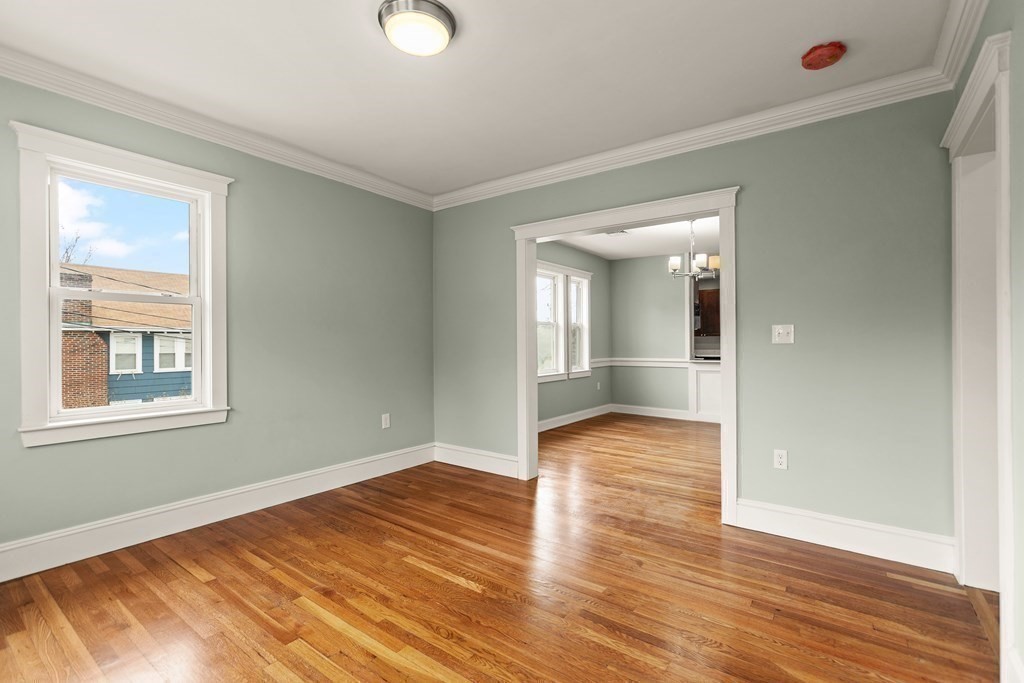 564 Lagrange Street, Unit 2 Boston, MA 02132 - Photo 10 of 27 a view of an empty room with wooden floor and a window