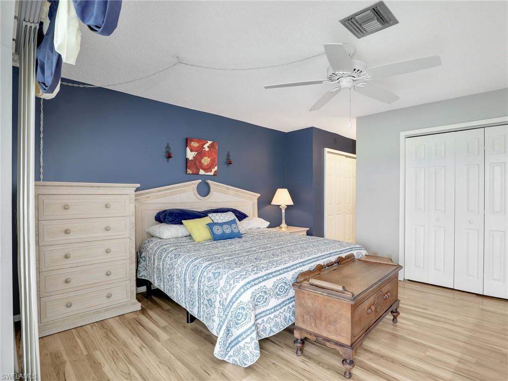 119 Harrison Road, Unit 16 Naples, FL 34112 - Photo 12 of 26 Bedroom with light wood finished floors and a ceiling fan