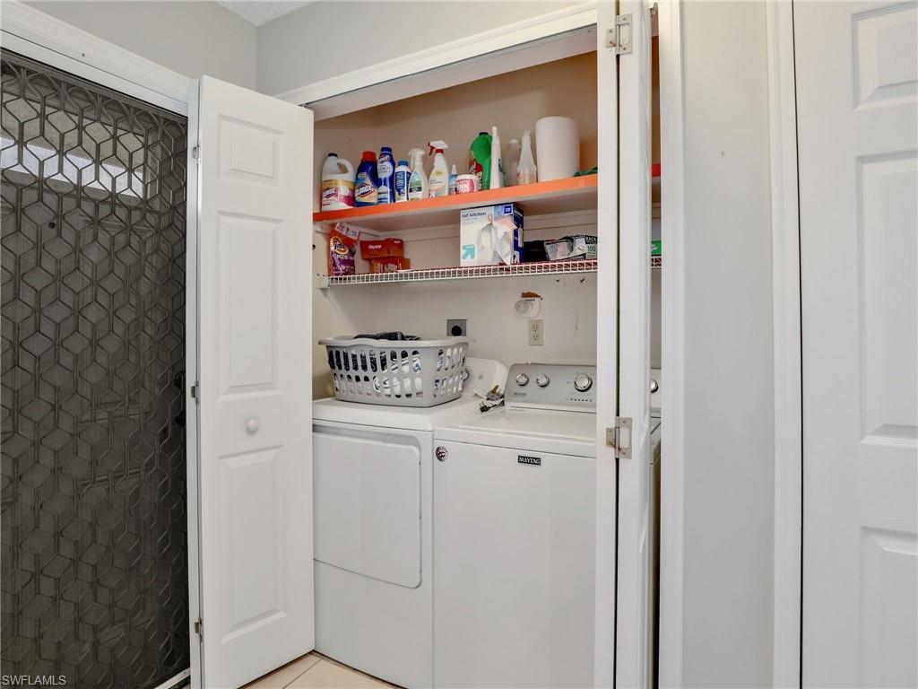 119 Harrison Road, Unit 16 Naples, FL 34112 - Photo 16 of 26 Laundry room featuring washing machine and dryer and light tile patterned floors