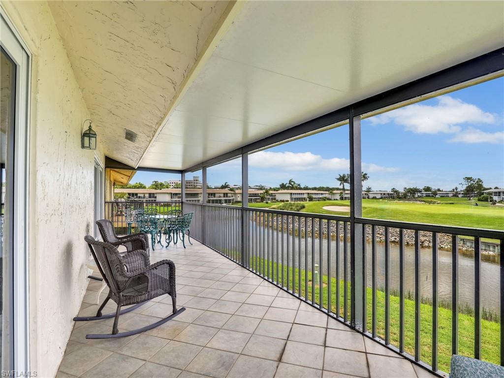 119 Harrison Road, Unit 16 Naples, FL 34112 - Photo 17 of 26 Sunroom featuring view of golf course, a water view, and a residential view