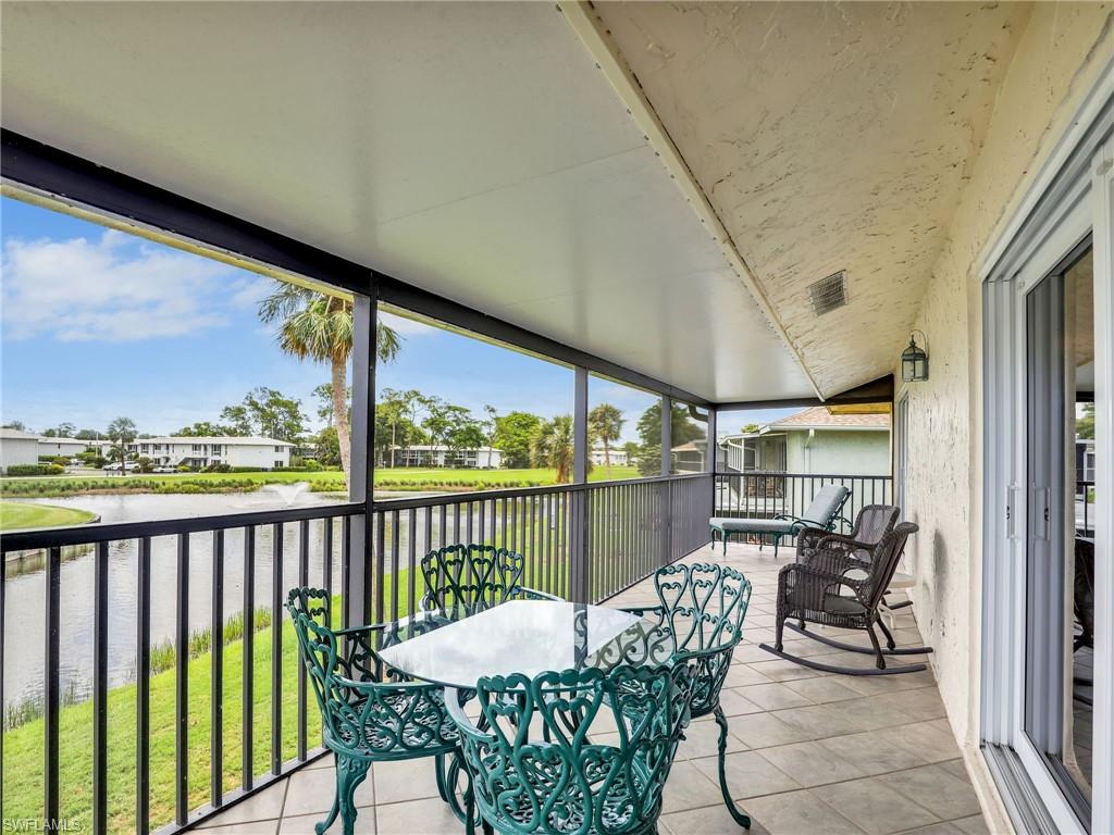 119 Harrison Road, Unit 16 Naples, FL 34112 - Photo 18 of 26 Sunroom with a water view and healthy amount of natural light