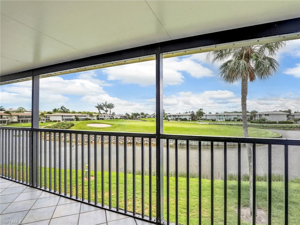 119 Harrison Road, Unit 16 Naples, FL 34112 - Photo 19 of 26 Unfurnished sunroom featuring golf course view, a residential view, and a water view