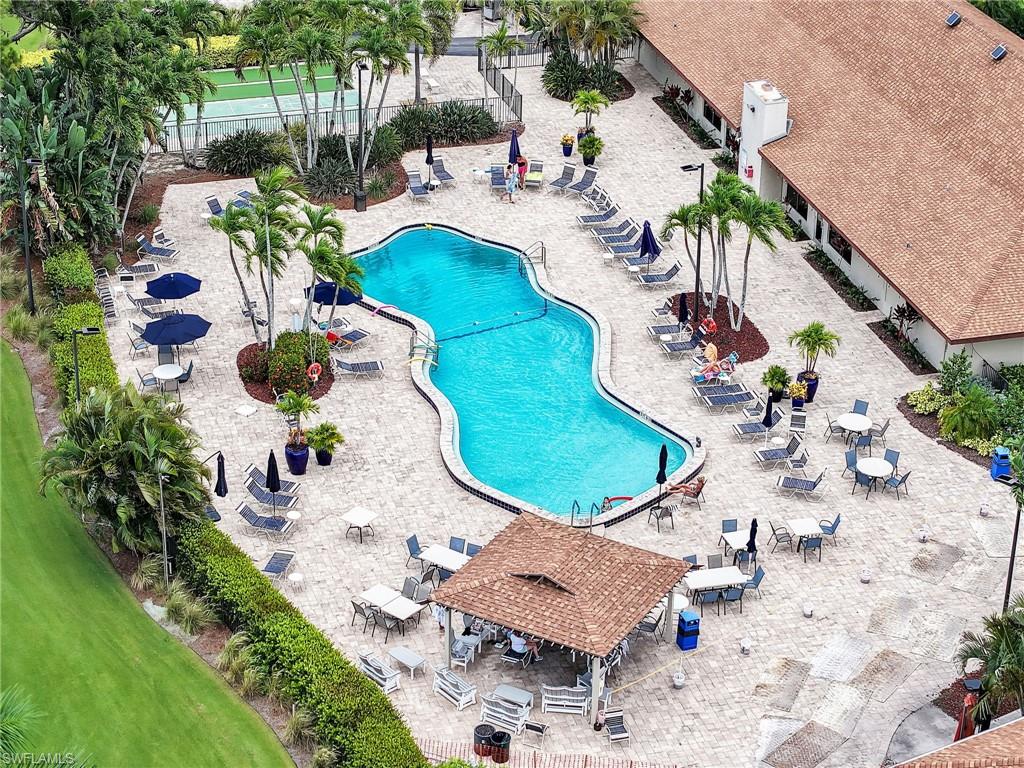 119 Harrison Road, Unit 16 Naples, FL 34112 - Photo 23 of 26 Community pool featuring a pergola