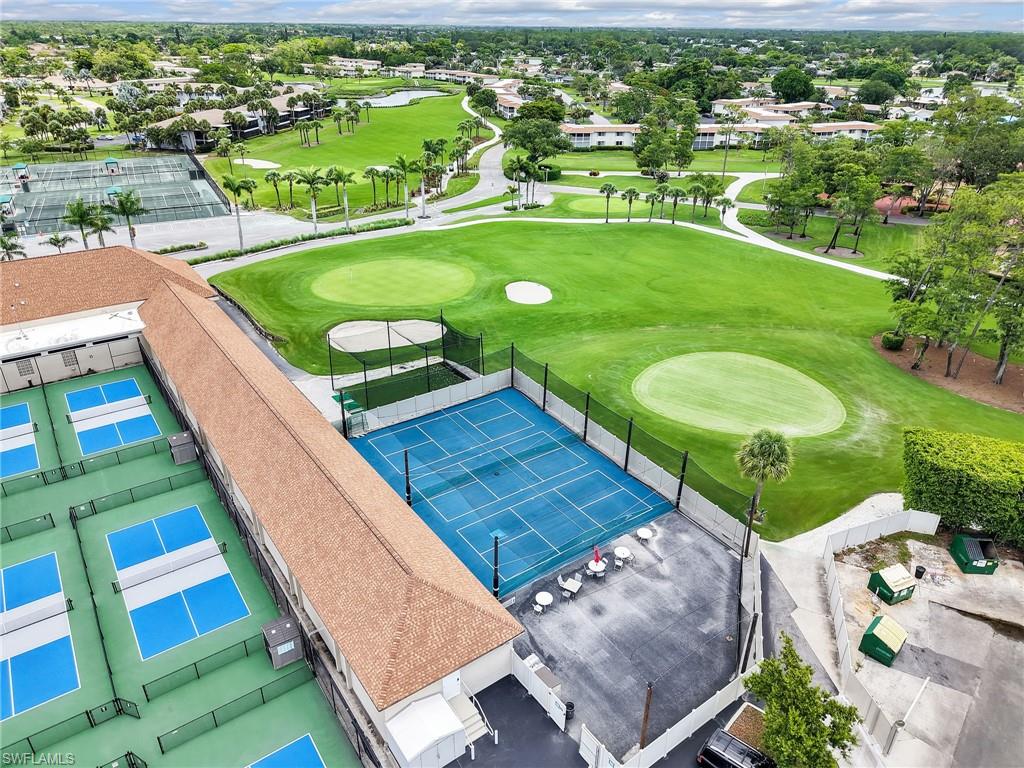 119 Harrison Road, Unit 16 Naples, FL 34112 - Photo 26 of 26 Bird's eye view of a golf club and a nearby body of water