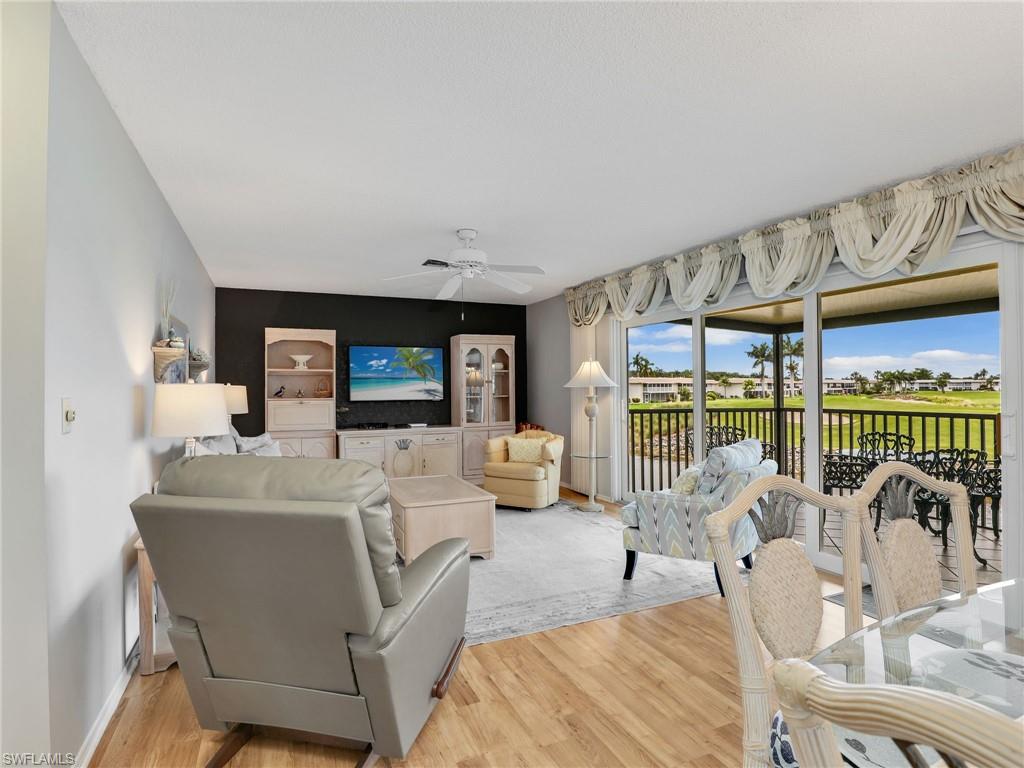 119 Harrison Road, Unit 16 Naples, FL 34112 - Photo 7 of 26 Living area featuring light wood-style flooring and ceiling fan