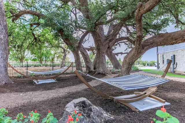 a backyard of a house with barbeque oven table and chairs
