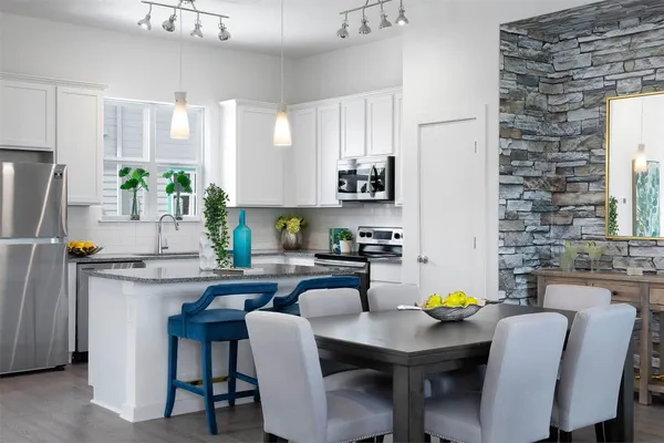 a kitchen with a table chairs and refrigerator