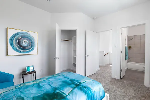 a bedroom with a bed and a bookshelf