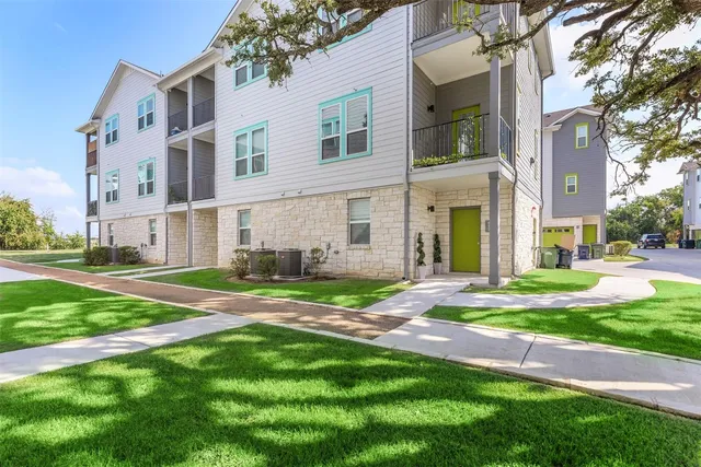 a view of a house with a yard and pathway
